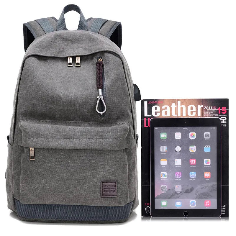 Canvas backpack with USB charging port showing computer compartment and zipper pocket