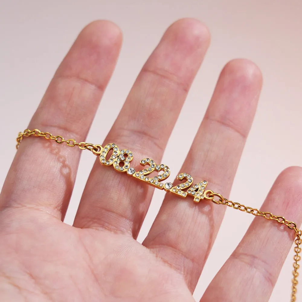 Stainless steel digital bracelet with diamond studs around LED display, shown in gold colour