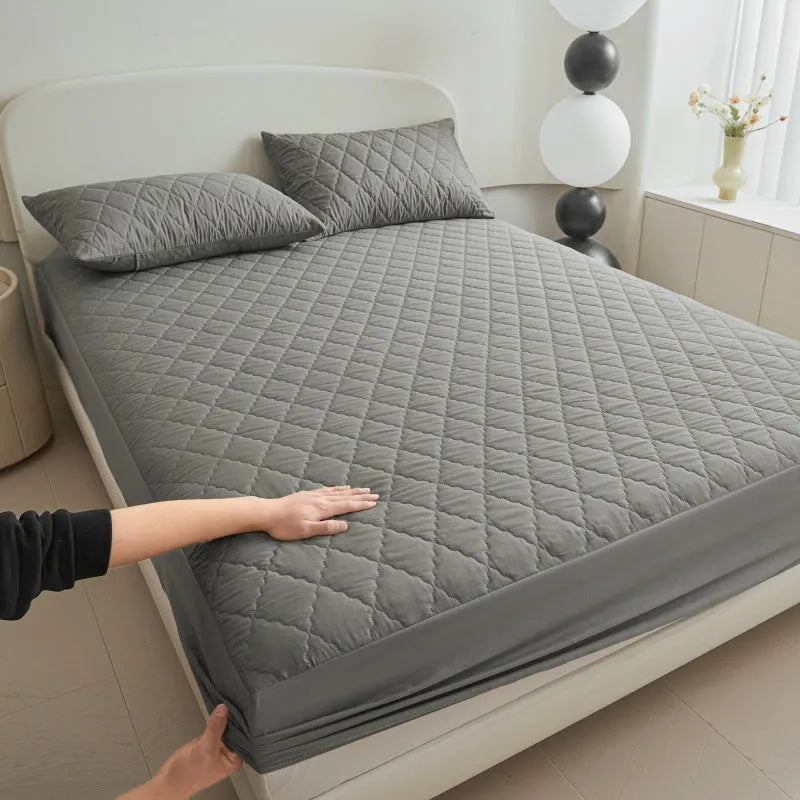 Diamond lattice quilted waterproof mattress protector in bamboo fibre shown on bed