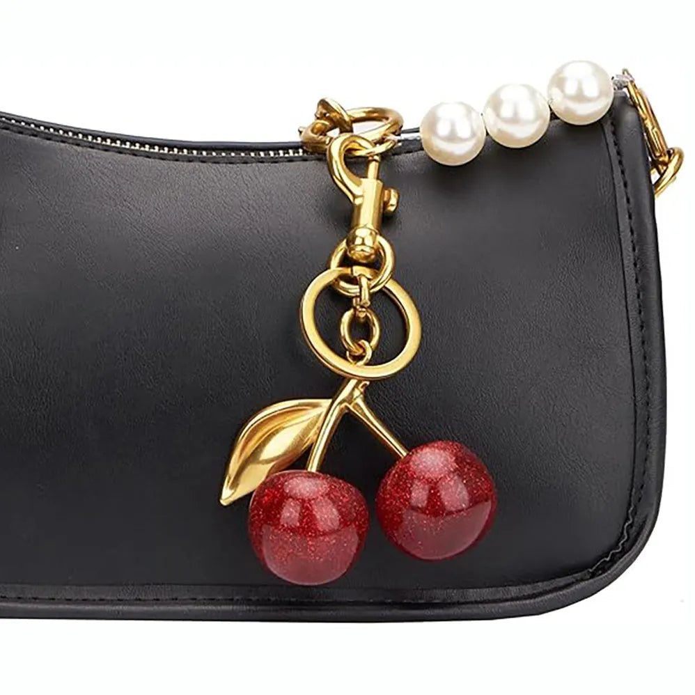 Red zinc alloy three-dimensional cherry pendant charm for key rings and bags.