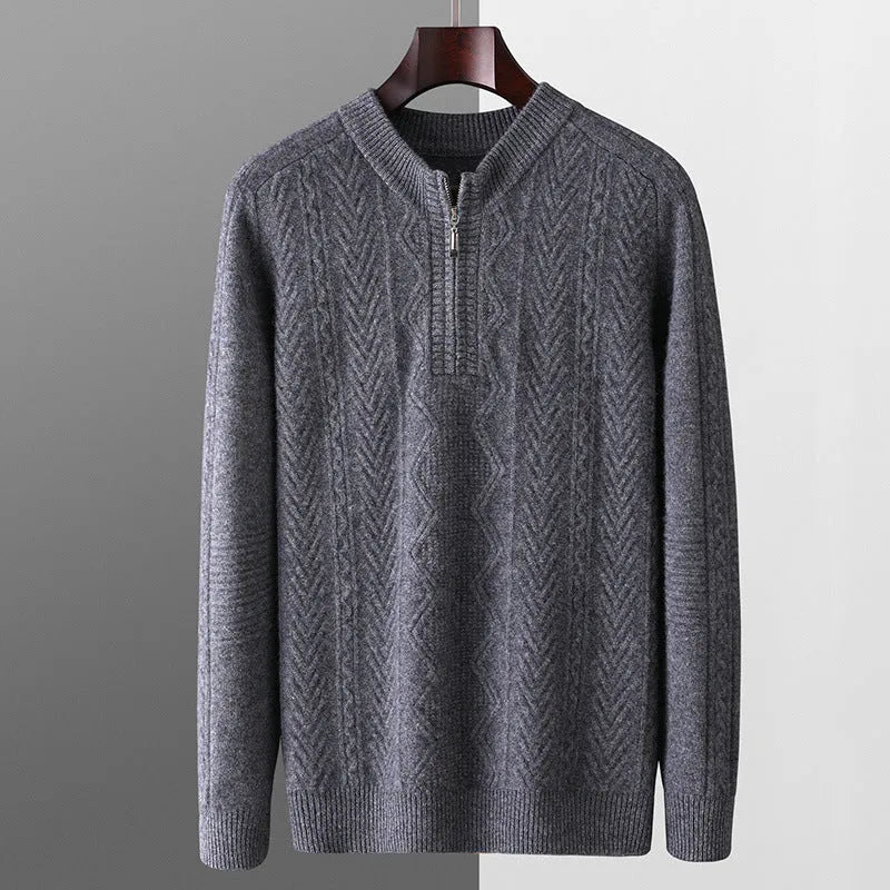 Man wearing a milky white half-zip wool sweater with a diamond pattern, showing loose fit and long sleeves.