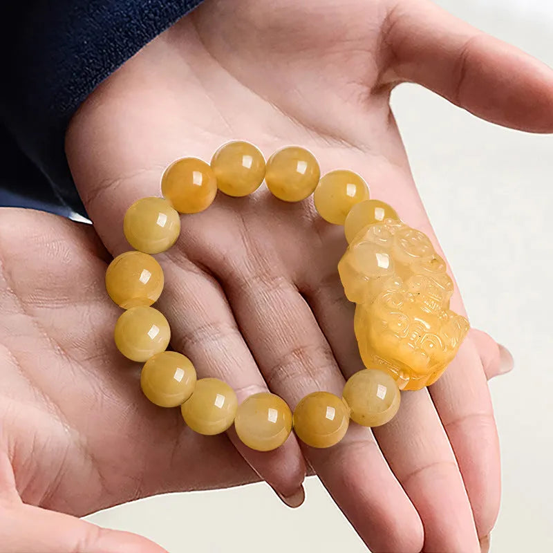 Carved Jinsi Jade money bracelet in Golden Thread Jade colour showing texture and bead detail.