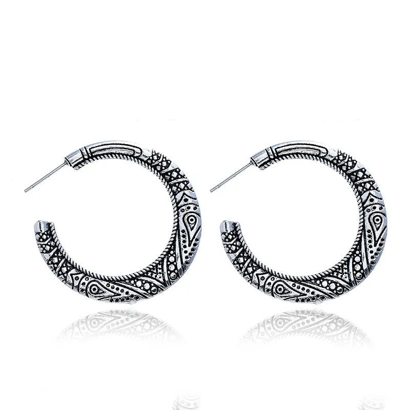 Vintage engraved C-shaped alloy earrings in bronze finish with detailed surface patterns