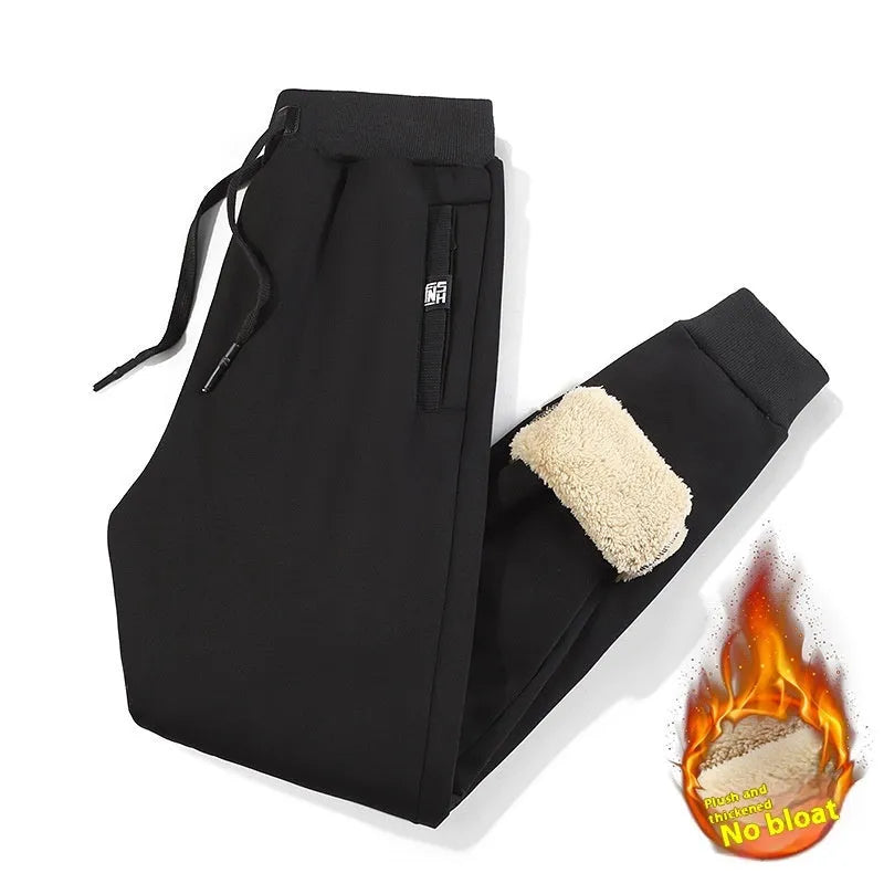 Grey fleece-lined men's oversized track pants with elastic waistband laid flat.