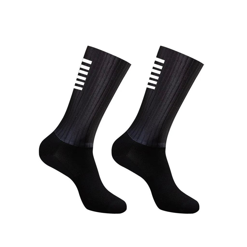 Pair of breathable athletic socks for running and cycling in orange colour on a grey background