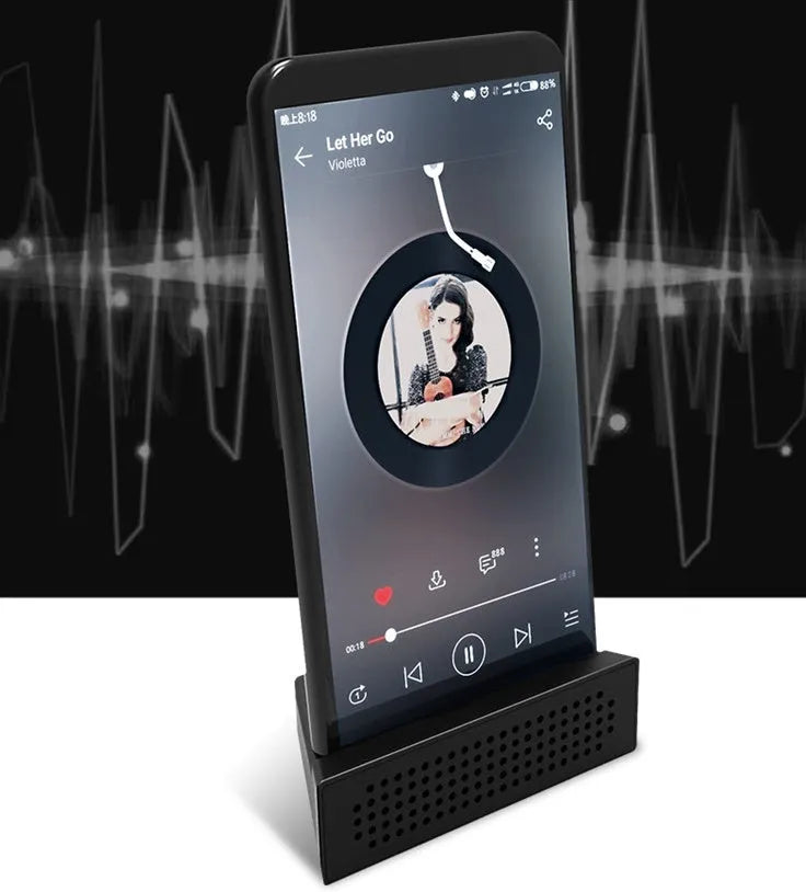 Mini mobile phone amplifier bracket on desktop enhancing smartphone sound in black, blue, pink or orange