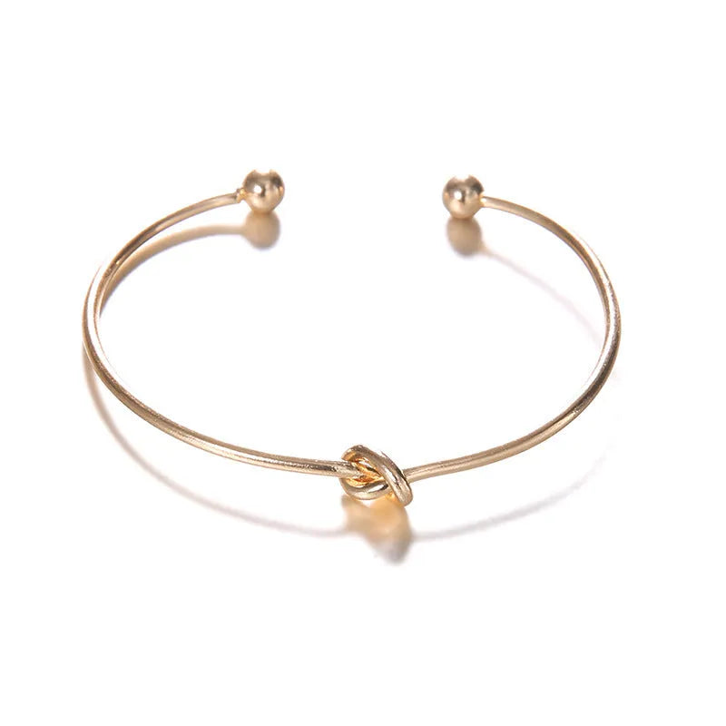 Women's vintage cuff arrow knotted bracelet in gold electroplated alloy