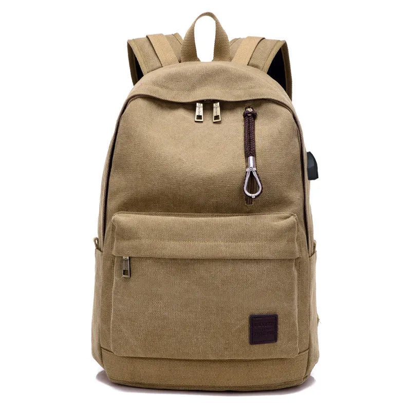 Canvas backpack with USB charging port showing computer compartment and zipper pocket