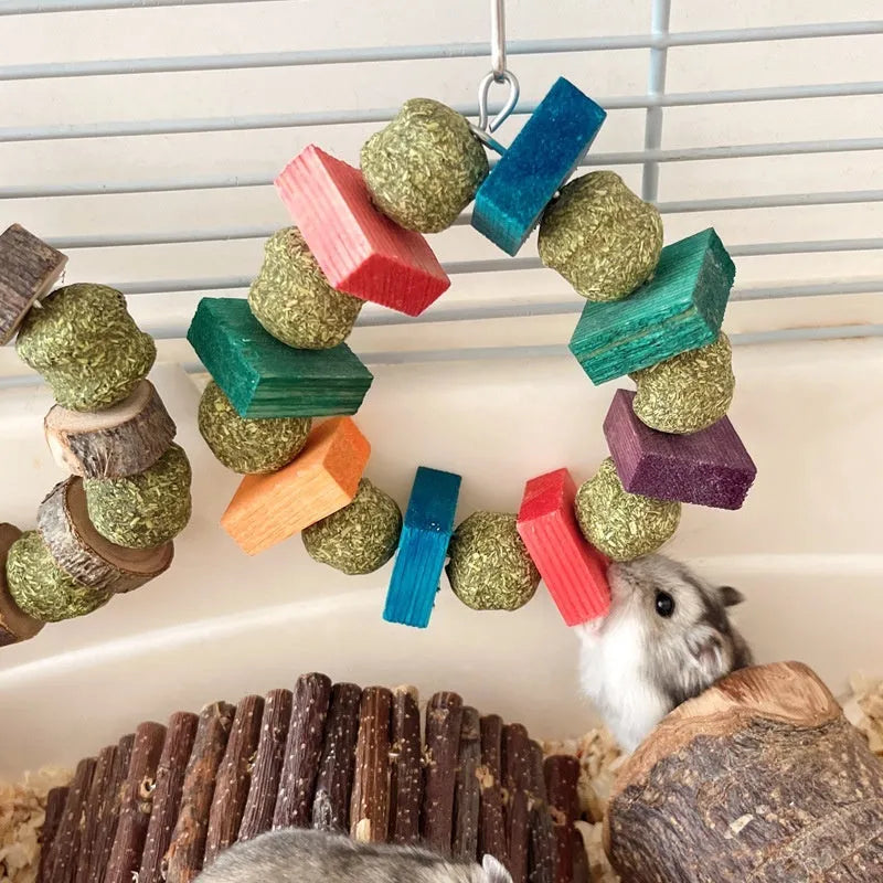 Applewood and straw ball ring chew toy for hamsters, guinea pigs, and rabbits on a white background.