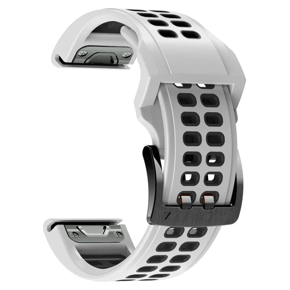 Close-up of a two-tone black and orange silicone watch strap with quick-release pins and a pin buckle.