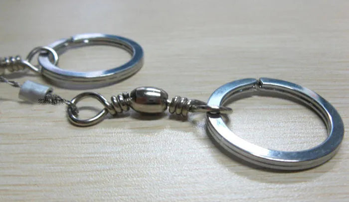 Stainless steel survival wire saw with thumb rings, total length 70cm for outdoor cutting tasks.
