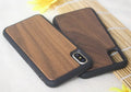 Wooden iPhone case with carbonized bamboo back and black TPU bumper frame on a table.