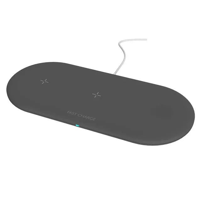 Black three-in-one wireless charging station for iPhone, Apple Watch and headphones on a desk.