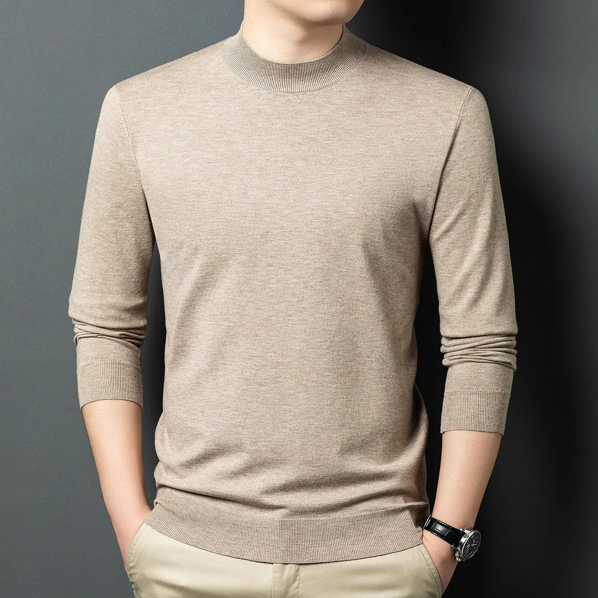 Men's round neck wool pullover sweater in a neutral colour with long sleeves, laid flat.