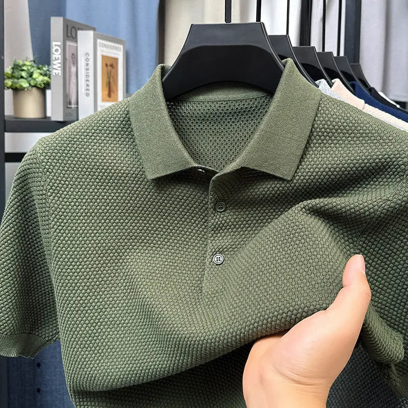 Man wearing a loose fit short sleeve cotton sweater in grey, showing the pullover style and relaxed silhouette.