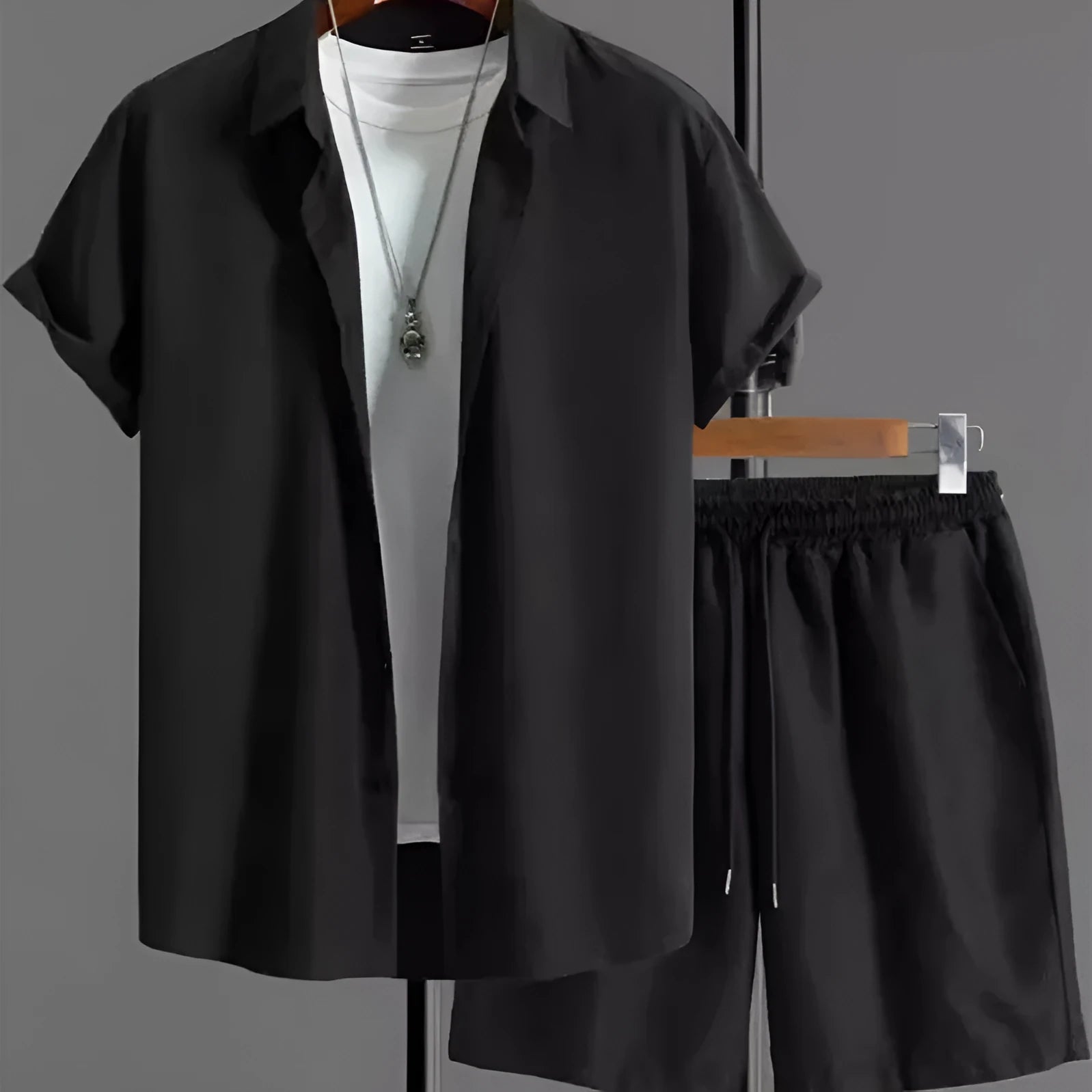 Man wearing black and white jacquard print short sleeve suit with shirt-style jacket and matching shorts