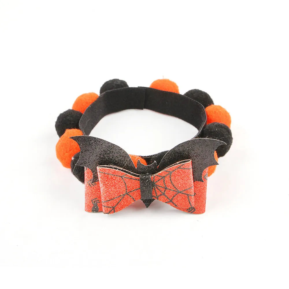 Halloween pet collar with a fur ball decoration in a pumpkin design, shown in size M