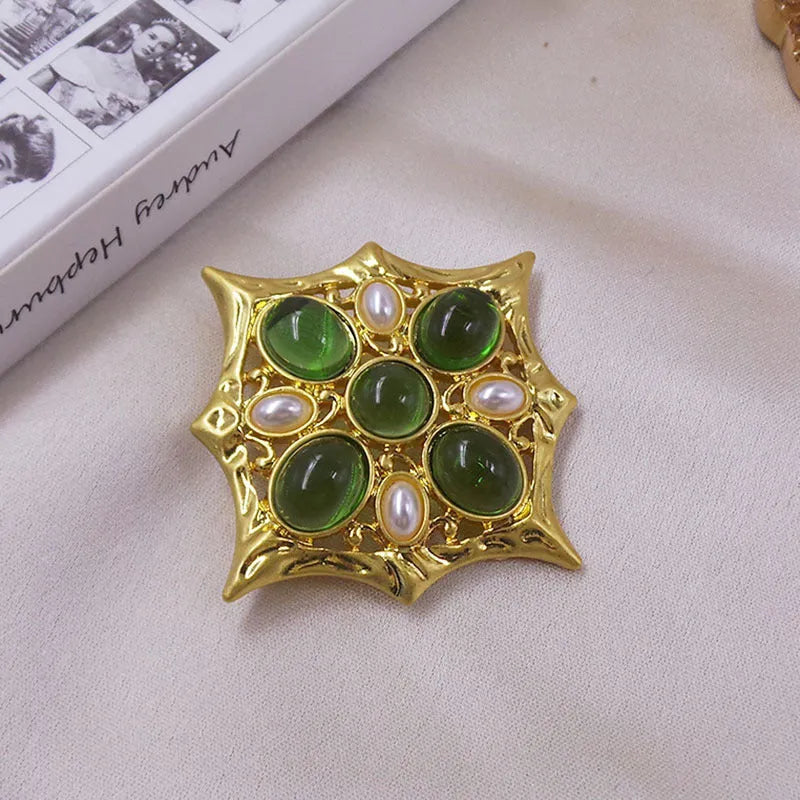 Close-up of vintage medieval baroque cross brooch with crystal details on zinc alloy base