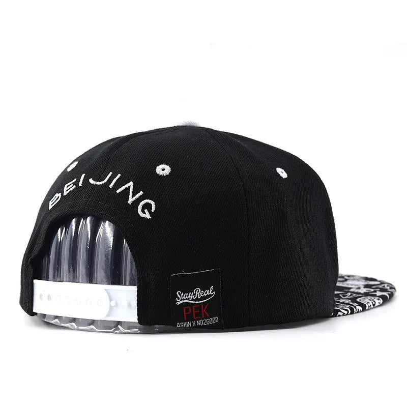 Cotton baseball hat with embroidered letters on a dome crown, shown in black and white.
