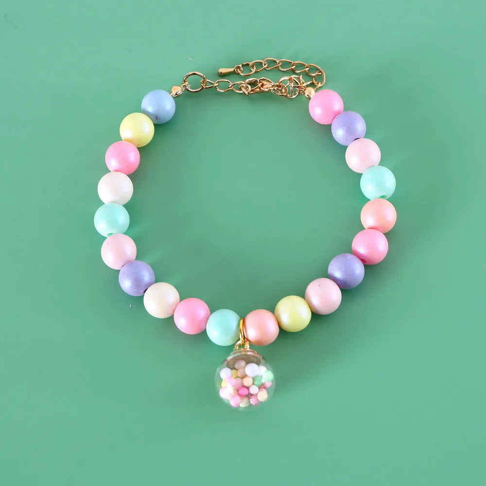 Macaron-colour pet collar with moon and pearl resin charms and a matching bracelet.