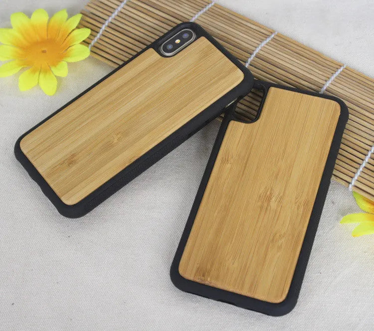 Wooden iPhone case with carbonized bamboo back and black TPU bumper frame on a table.