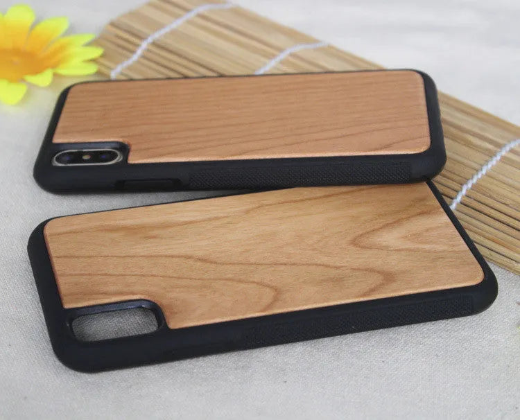 Wooden iPhone case with carbonized bamboo back and black TPU bumper frame on a table.