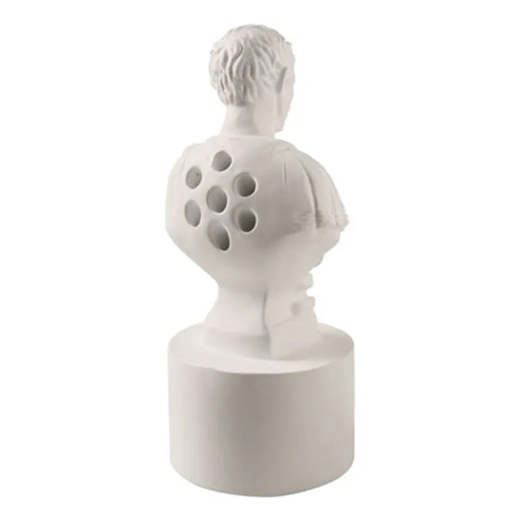 White synthetic resin pen holder with sculpted American creative character design on a desk.