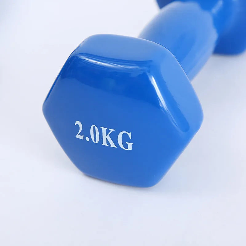 Set of bright red and blue plastic fitness dumbbells on a light floor.