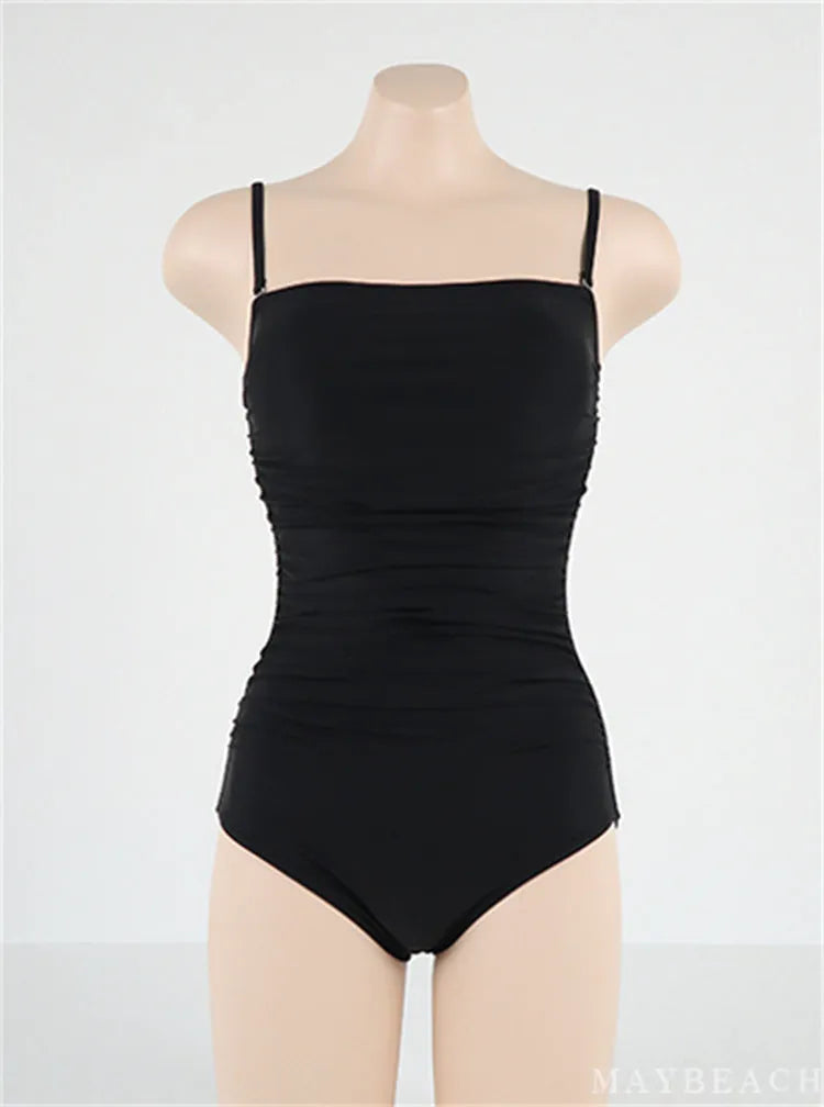 Women's sling style one-piece swimsuit with belly pleats in solid colour options