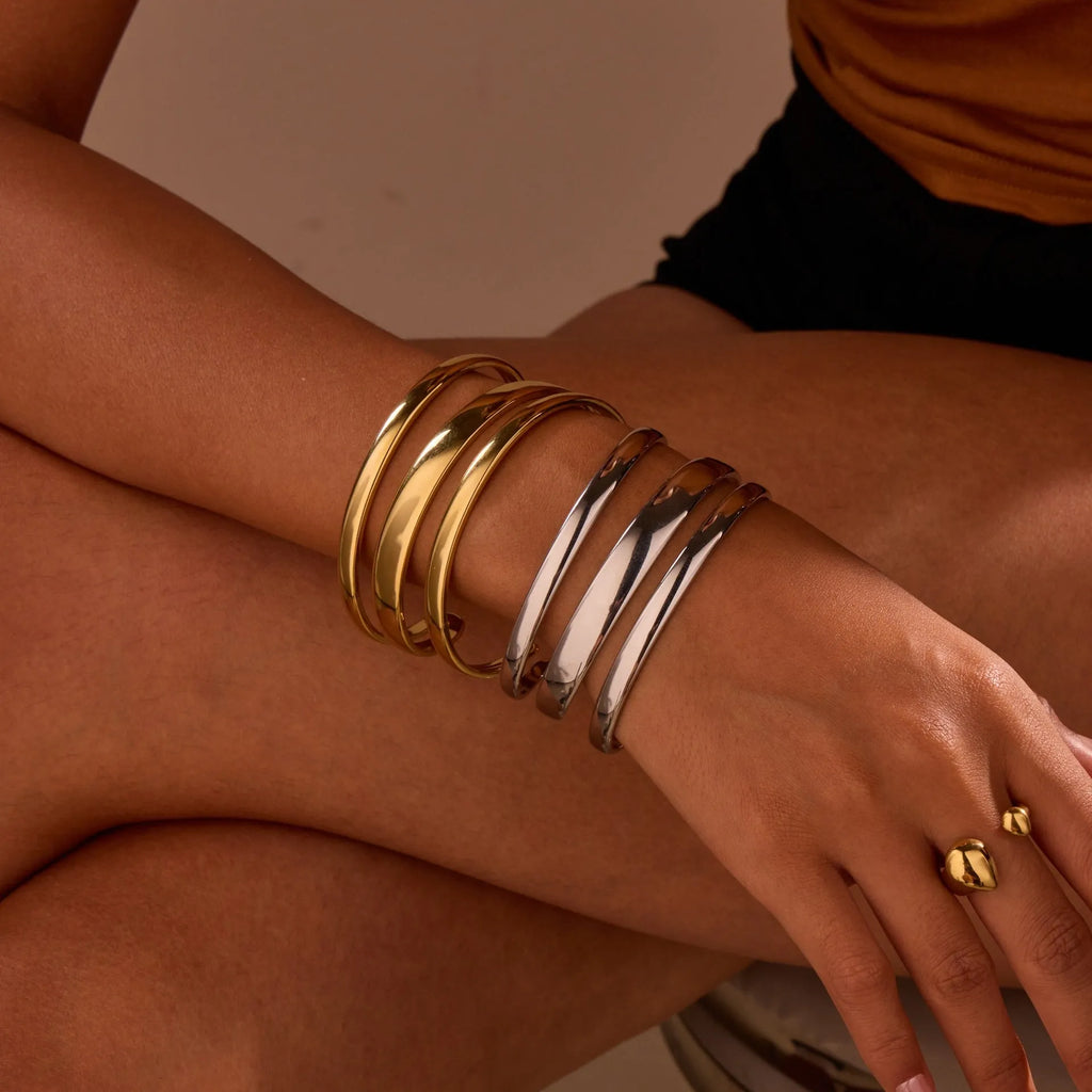 A geometric line design stainless steel bracelet with a simple opening clasp, shown in a gold electroplated finish.