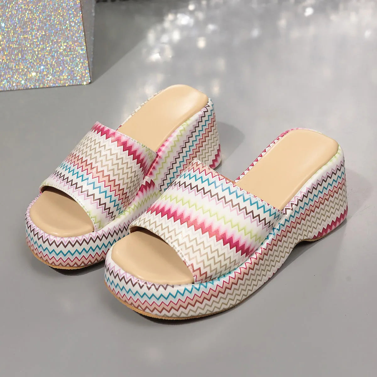 Women's beige wedge sandals with blue wave print design, fish mouth toe, and a thick rubber sole.