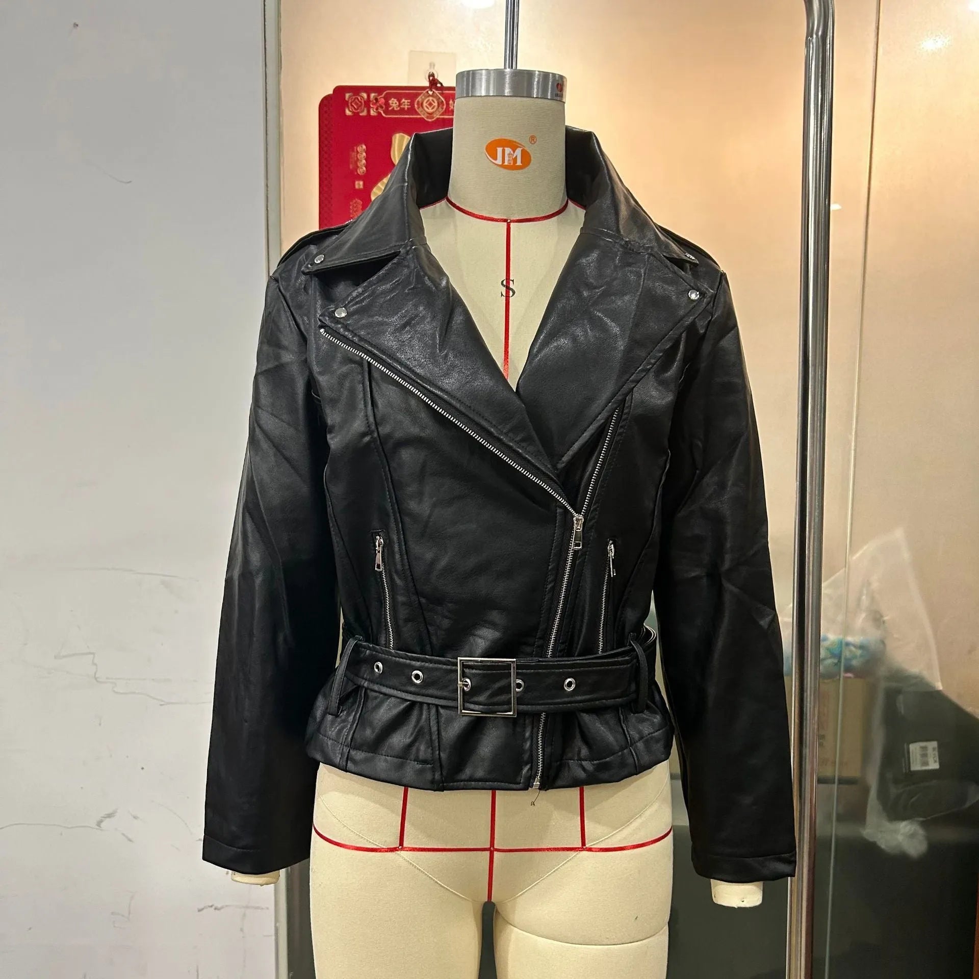 Black punk-style locomotive jacket with a drawstring waist, Peter Pan collar, and regular sleeves on a hanger.