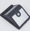 Four white solar-powered LED sensor lights for outdoor wall mounting with adjustable heads.