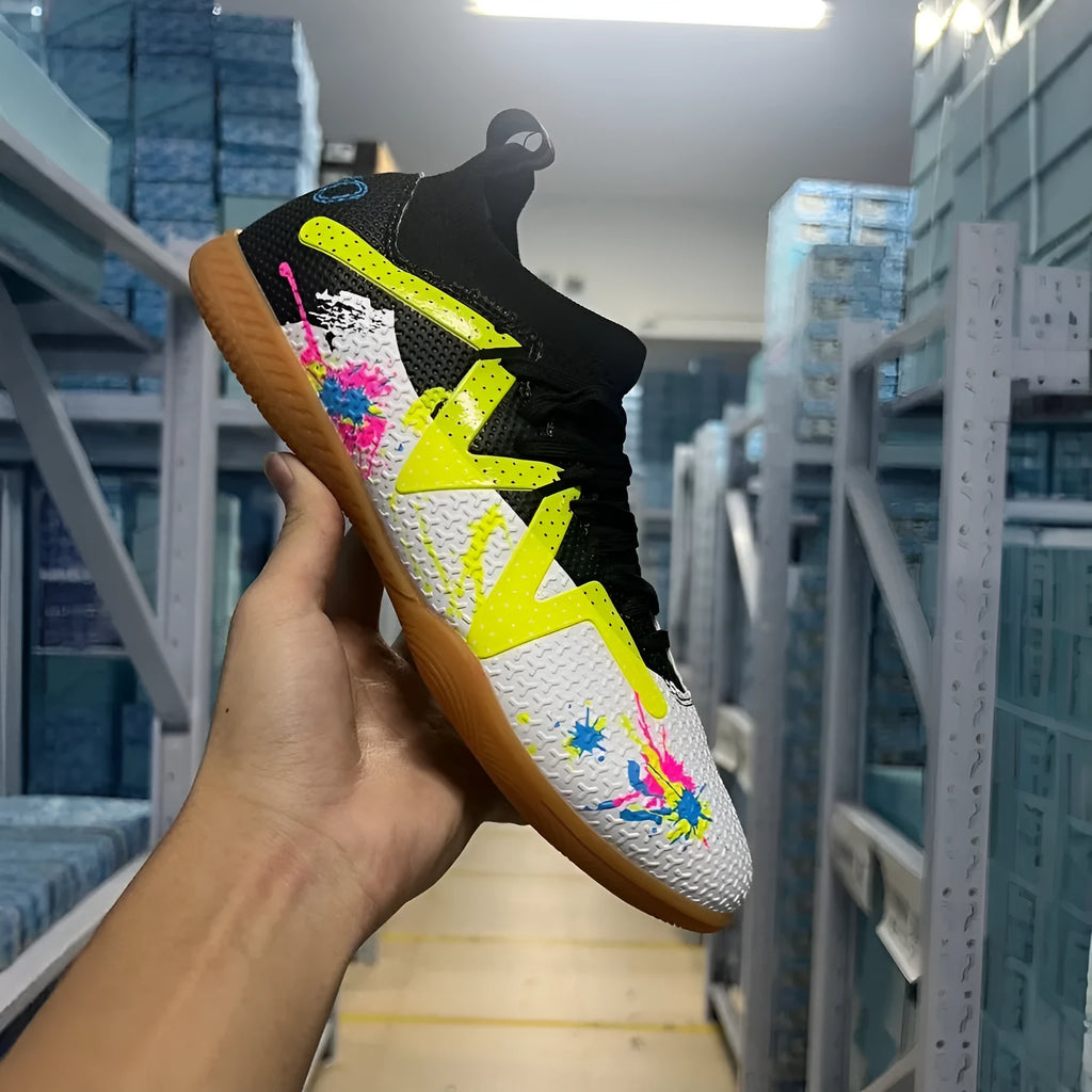 Adult low-top football boots with non-slip rubber outsole, available in black and yellow, white, and black colourways.