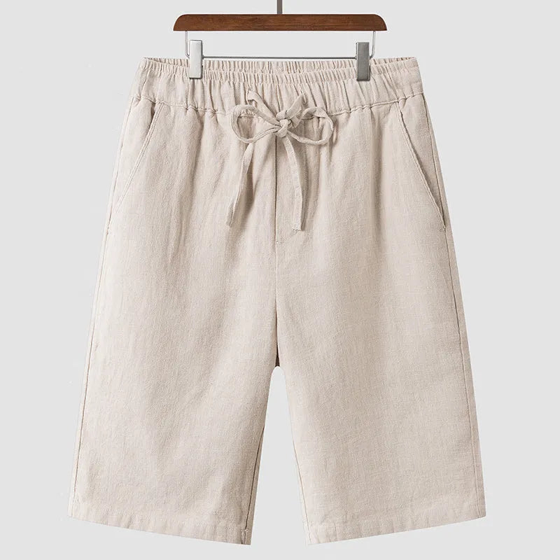 Men's linen shorts in loose cropped design with elastic waistband, shown in available colours
