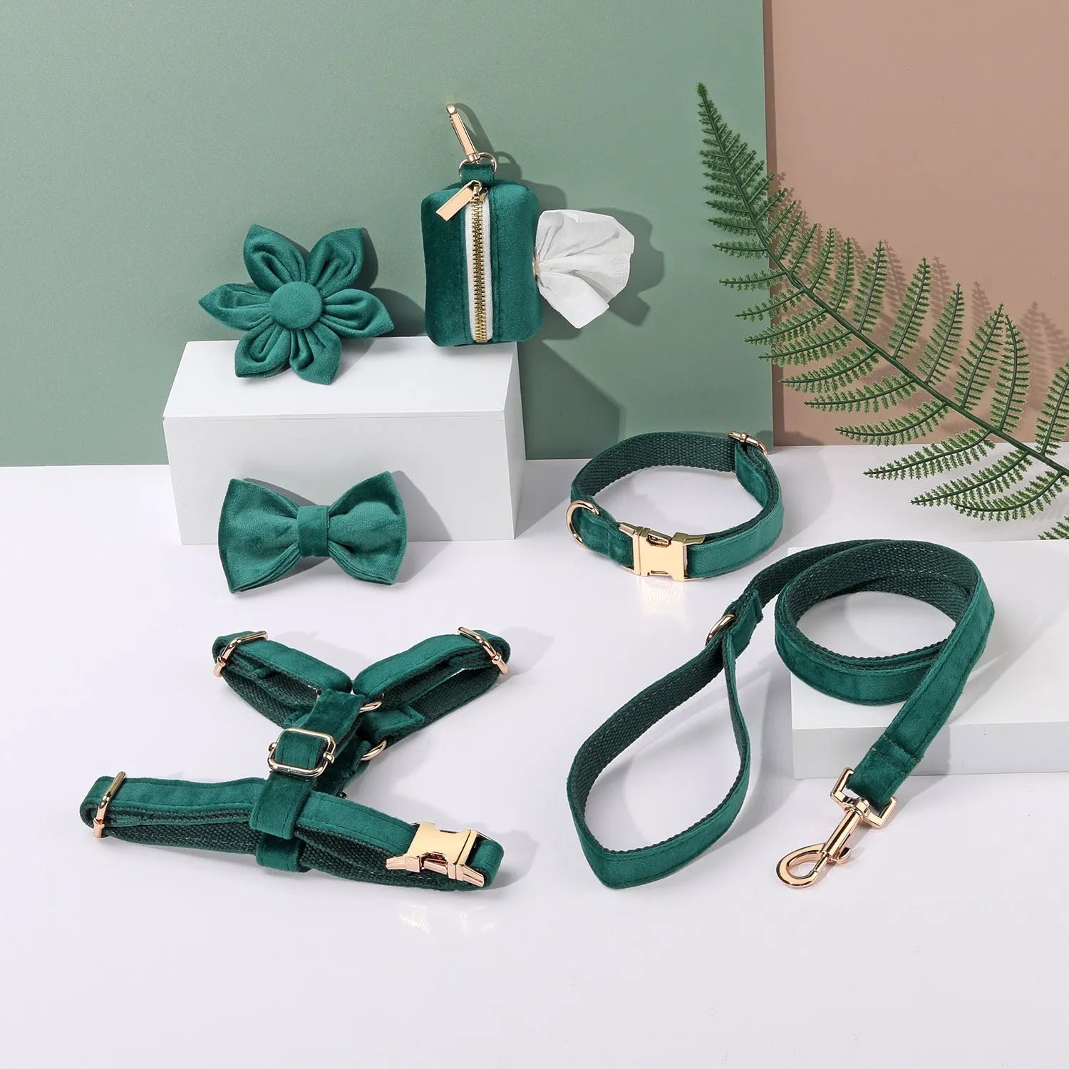 Red velvet dog collar and leash set with chest strap, bow tie, and decorative flower accessories.