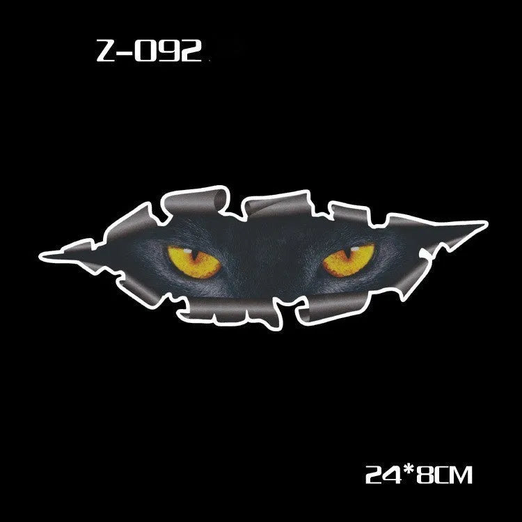 A pair of reflective cartoon eye car stickers on a vehicle rearview mirror.