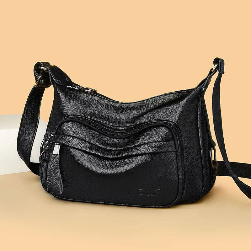 Large black PU shoulder bag with multiple internal compartments showing phone and document sections
