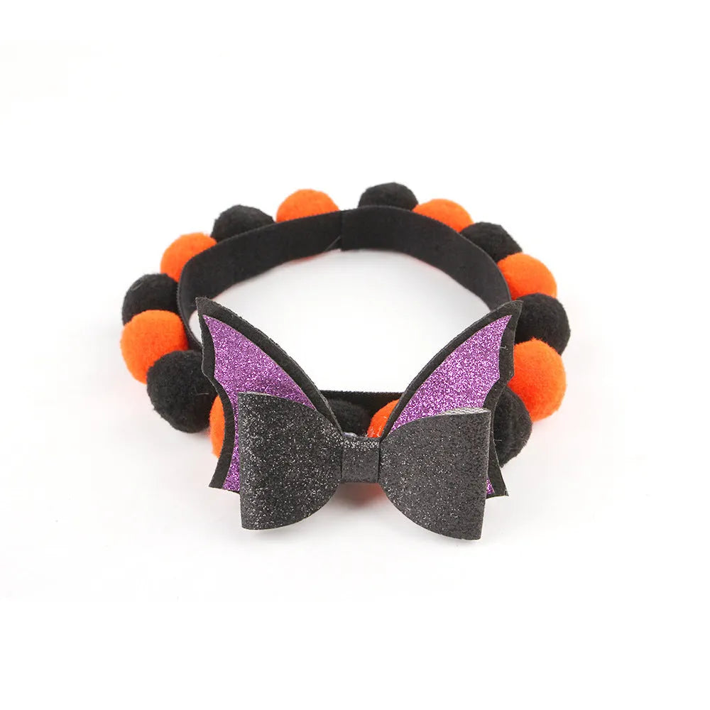 Halloween pet collar with a fur ball decoration in a pumpkin design, shown in size M