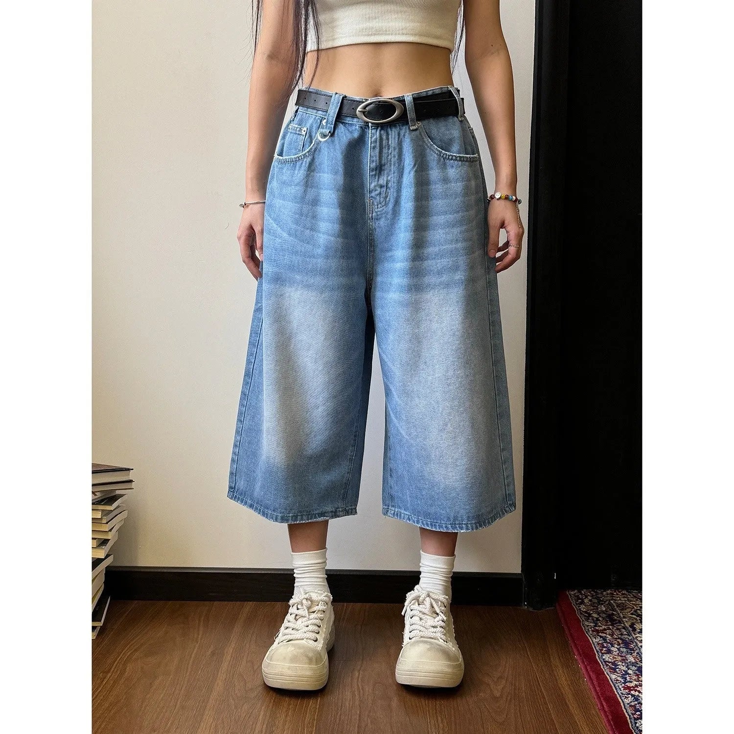 Men's straight-leg loose fit denim shorts in light blue on a neutral background.