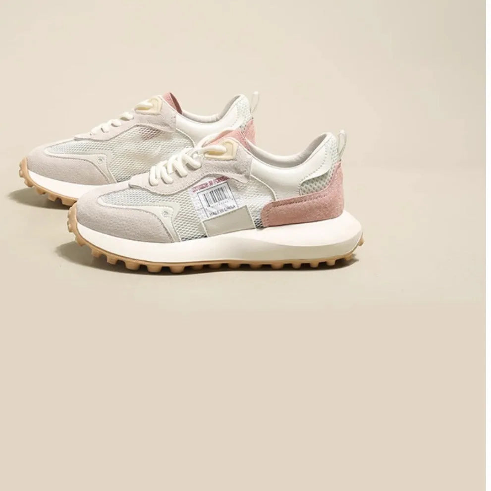 Women's low-top retro sneaker in grey with round toe, rubber sole, and mesh lining.