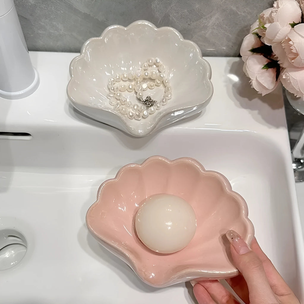 Shell-shaped plastic soap dish in white or pink for bathroom use
