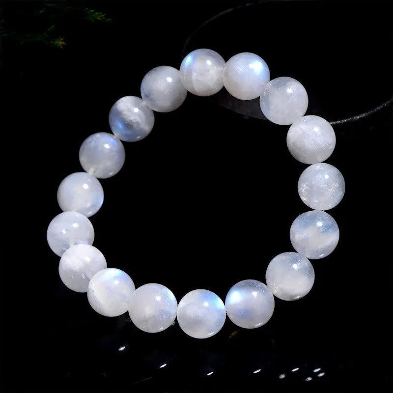 Natural blue moonlight moonstone round bead bracelet showing polished geometric beads on wrist