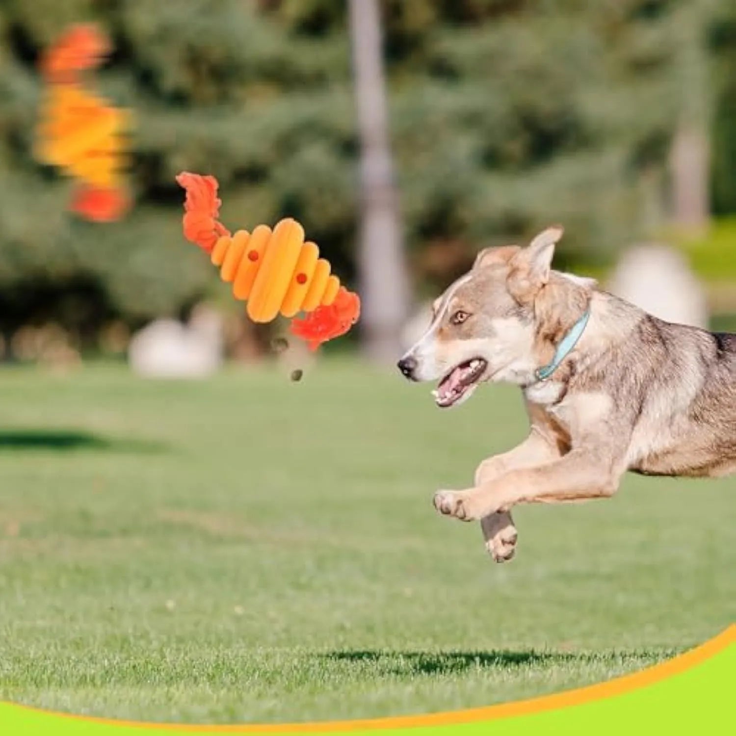 Green and yellow silicone dog ball with rope handle for tug-of-war and treat dispensing