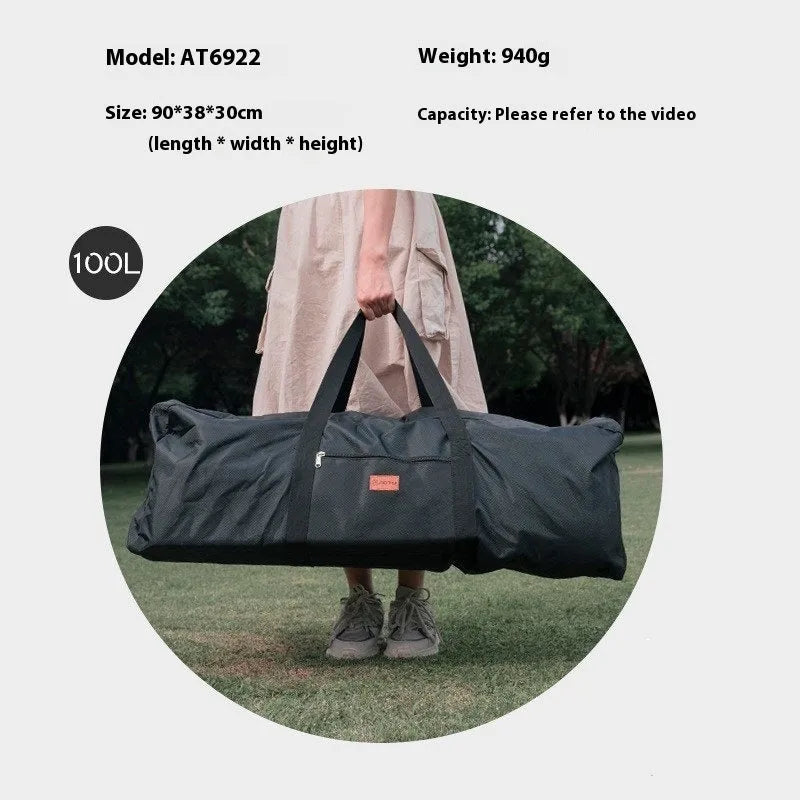 Green waterproof camping storage bag with carry handles, shown carrying a folding table and chairs.