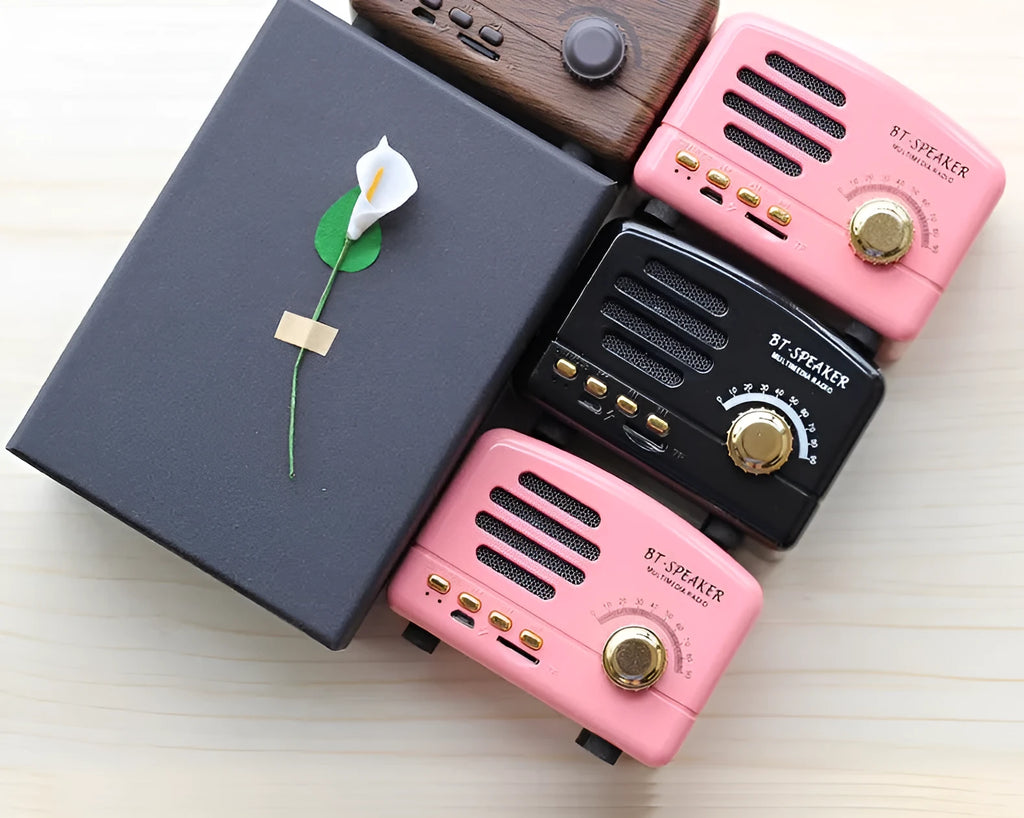 Compact vintage-style wood grain finish Bluetooth speaker on a wooden surface.