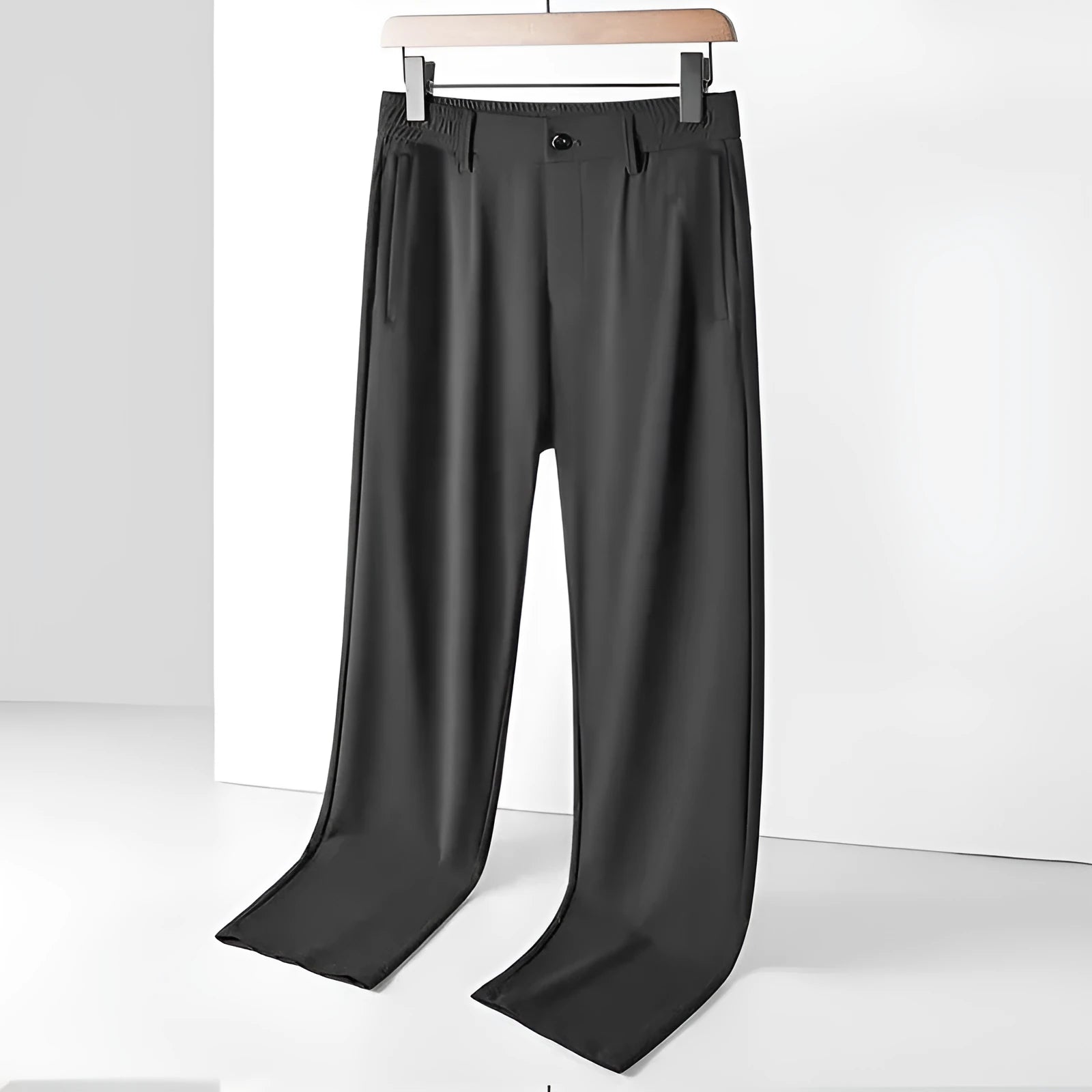 Man wearing black Ice Silk straight-leg loose trousers with an elasticated waist for leisure.