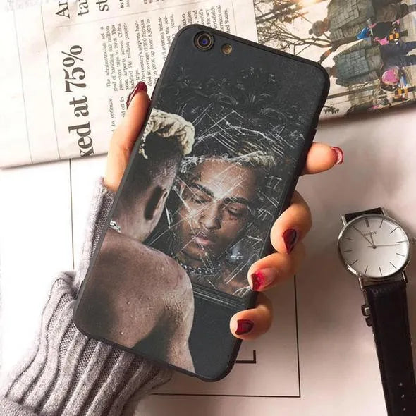 Transparent matte iPhone case featuring an Xxxtentacion graphic design, showing half-wrapped sides.