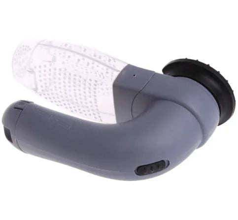 Grey handheld electric pet hair remover brush with soft rubber head, shown removing fur from upholstery.