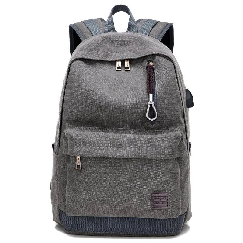 Canvas backpack with USB charging port showing computer compartment and zipper pocket